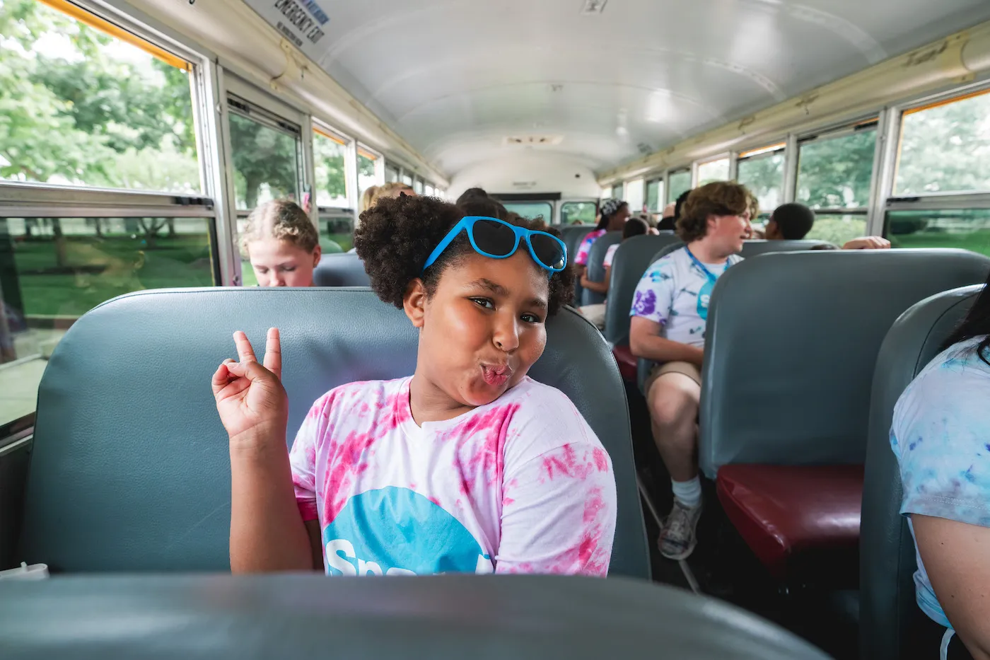 Students riding a Detroit Bus Company school bus