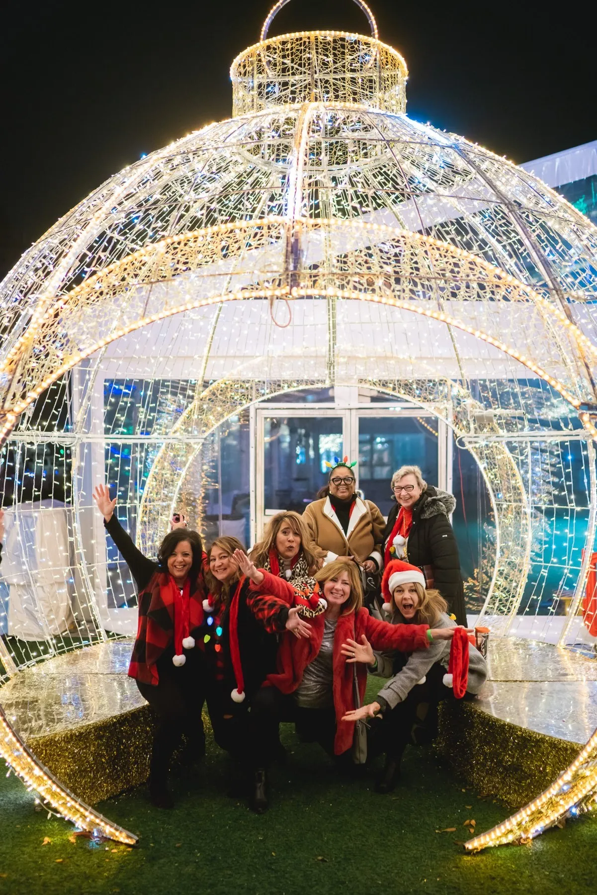 A group inside a giant walk-in glowing ornament