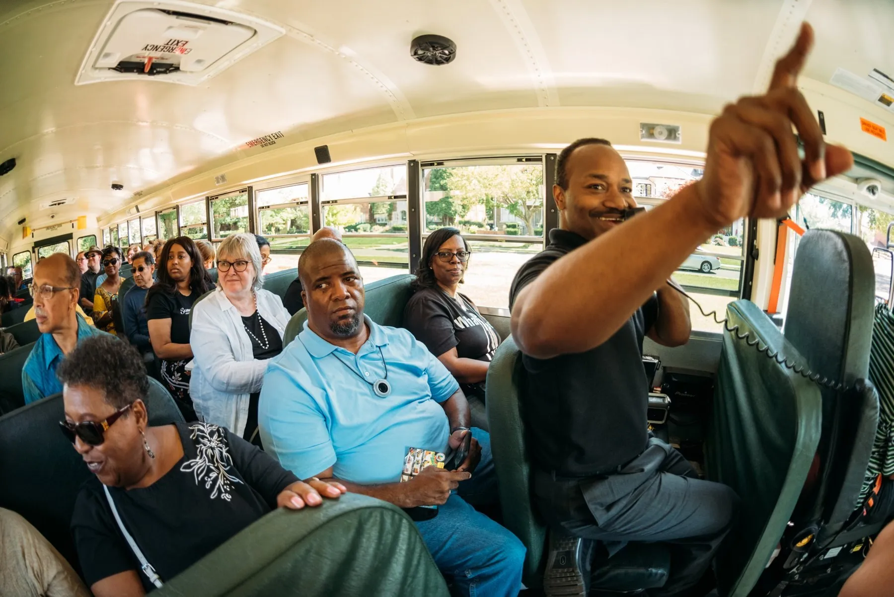 A DBC tour guide mid-story, pointing out the bus window